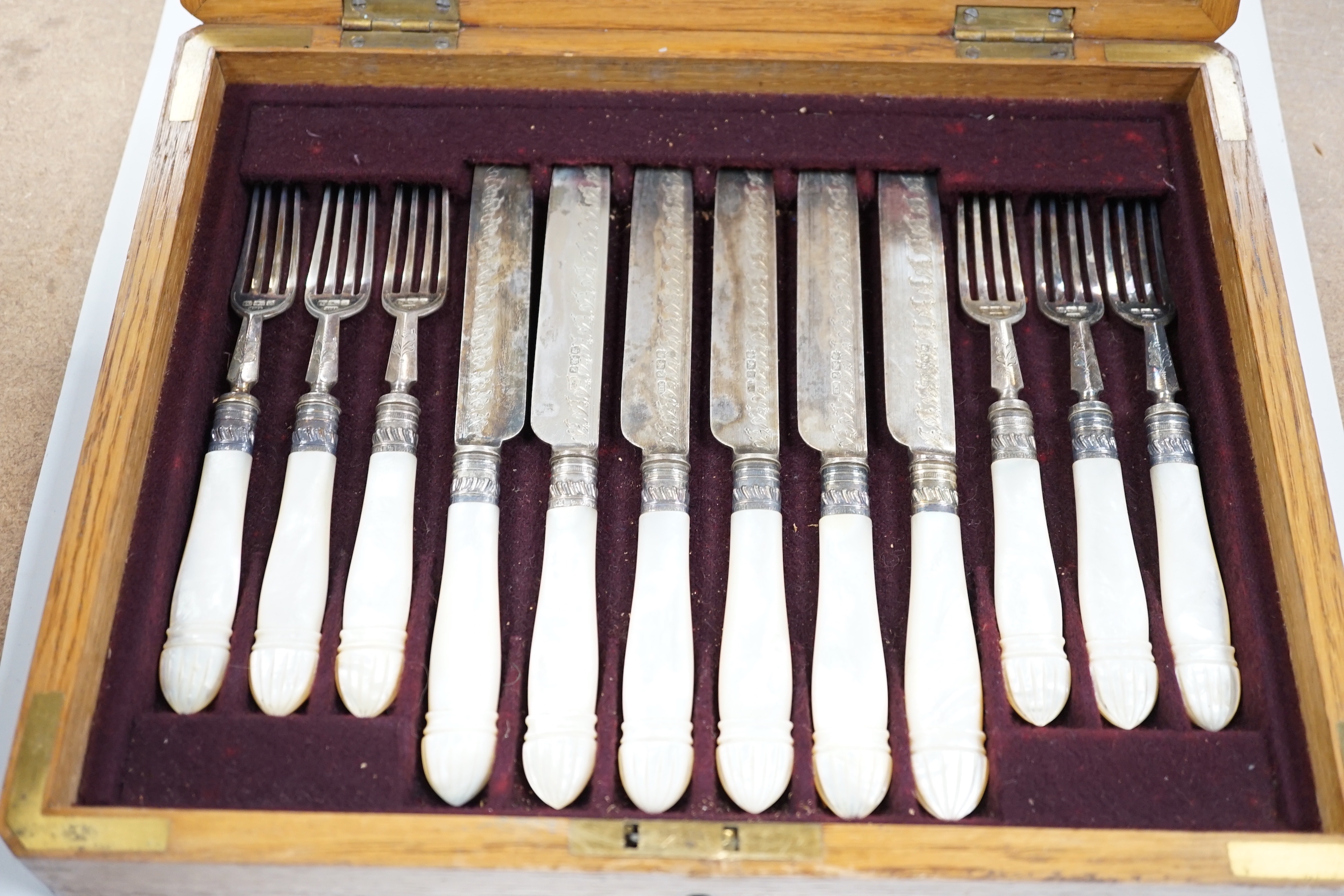A cased set of twelve pairs of late Victorian mother of pearl handled silver dessert eaters, by Henry Harrison, Sheffield, 1892/3, knife 20cm.